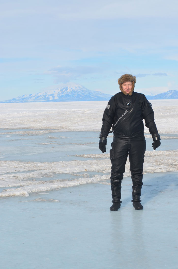 Dr. Amanda Kelley standing on the sea ice after a research dive in McMurdo Sound, Antarctica.