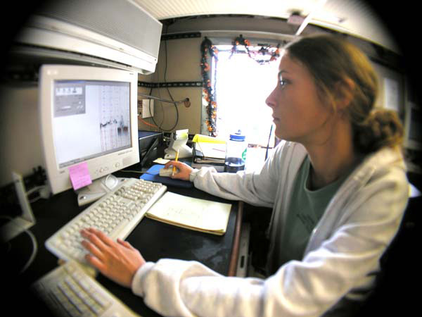 Andrea Quattrini monitors sonar data while the team assesses a potential dive site.