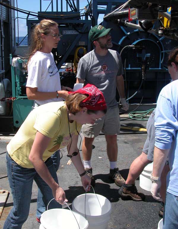 Sarah L'Heureux of the Woods Hole Oceanographic Institution participates in the 'bucket brigade', 