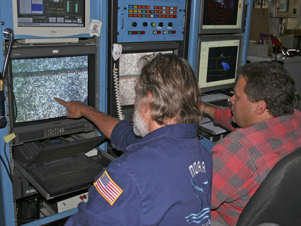 Ed Bowlby points to the Lophelia patch on the ROV monitor.