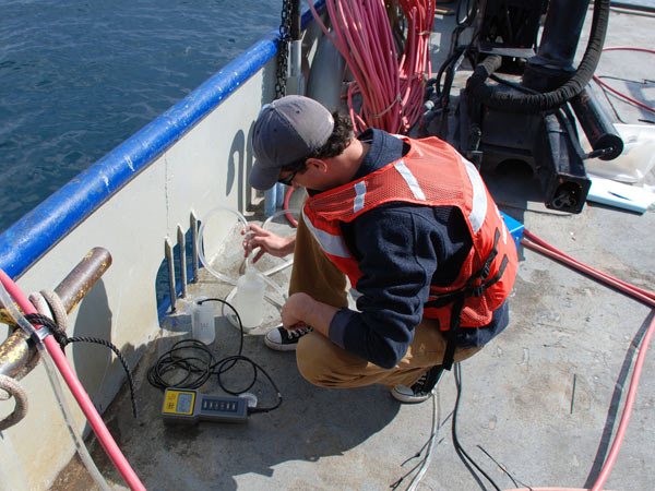 A hose attached to the ROV's umbilical pumps groundwater from the bottom of the sinkhole to the surface for sample collection.