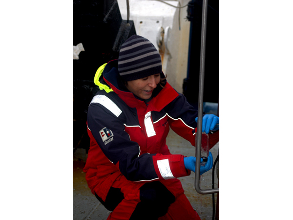 Marlene Jeffries fills a sample bottle with water from a Niskin bottle mounted to the rosette. During the 2009 RUSALCA expedition, she will collect close to 1000 samples, which will be analyzed to reveal the Arctic Ocean's absorption of atmospheric carbon dioxide.