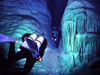 Divers swim between massive submerged stalagmites in Crystal Cave, Bermuda.