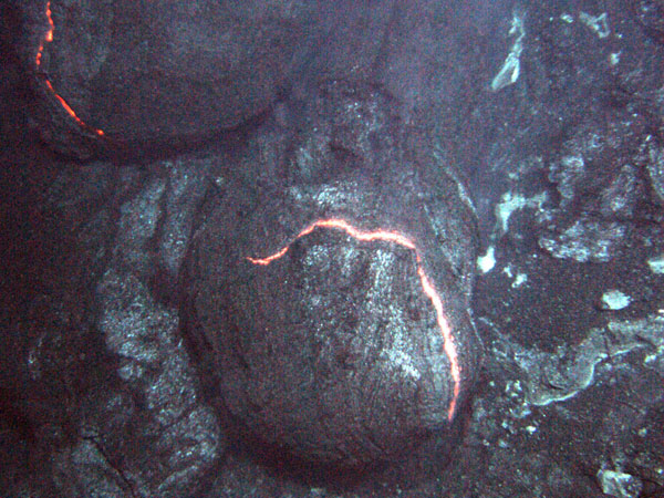 These are consecutive images.  The orange glow of superheated magma, about 2,200 degrees Fahrenheit, is exposed as pillow lavas extrude from the eruption. These images are approximately three feet across in an eruptive area approximately the length of a football field that runs along the summit.cross. 