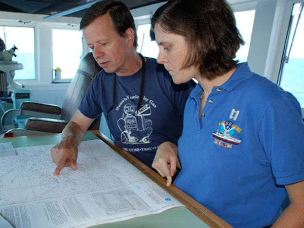 Operations Officer Lieutenant Nicole Manning confers with chief scientist Chuck Fisher about the next days dive plan. 