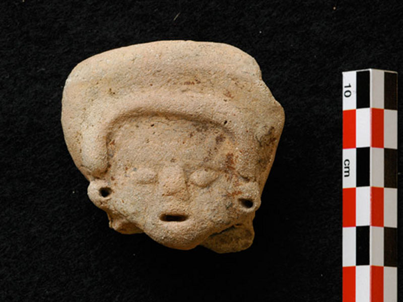 A fragment of a Middle Preclassic figurine that was recovered in 2008. Members of the PCE dated the figurine to the Middle Preclassic (c. 800 – 600 B.C.) based on stylistic characteristics. This figurine probably arrived with the island’s first permanent inhabitants.