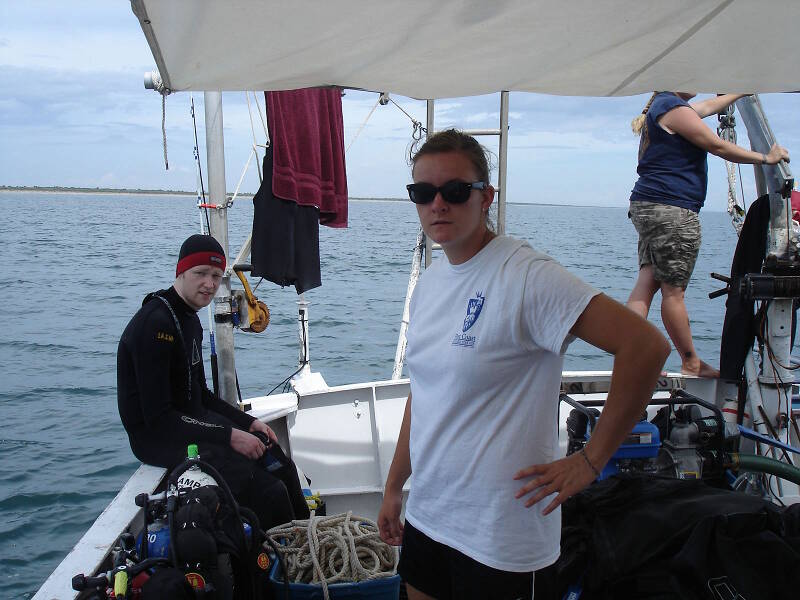 At left, student volunteer Florian Funk prepares for a dive. Olivia McDaniel at center is surface support for this dive. Florian is from Germany and was a high school exchange student in St. Augustine in 2009, when he was certified as a scuba diver in LAMP’s high school underwater archaeology program. He has since returned several times to volunteer with LAMP and is currently in Florida for a college internship.