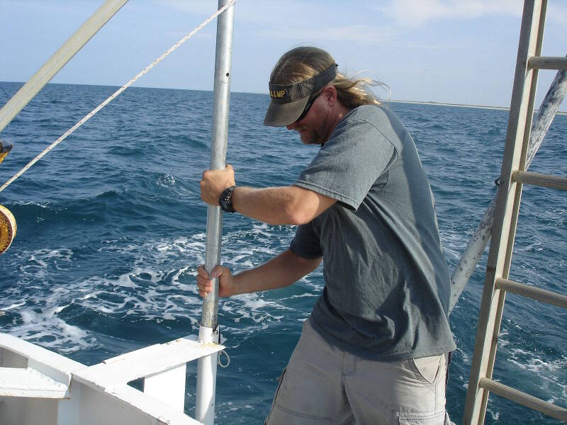 Chuck Meide securing the subbottom profiler at the stern of the boat.