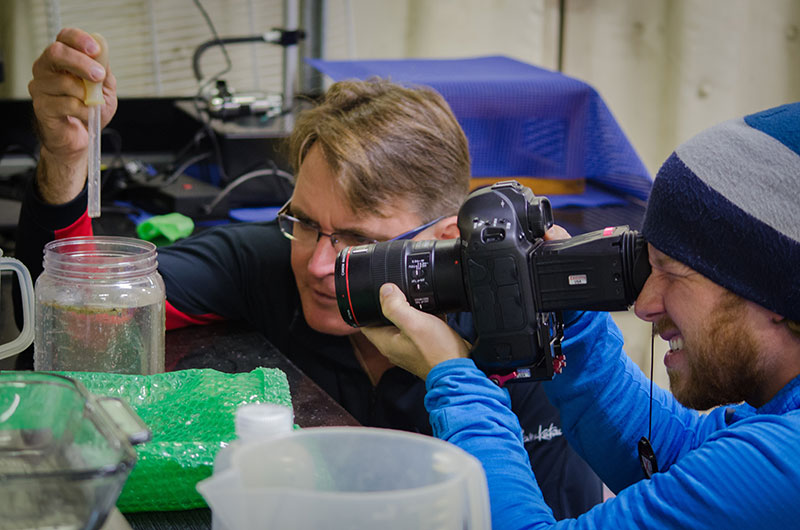 Mathew Broughton, cinematographer for Microcosm, takes footage of Dr. Dhugal Lindsay examining a jar of plankton collected from the plankton net.