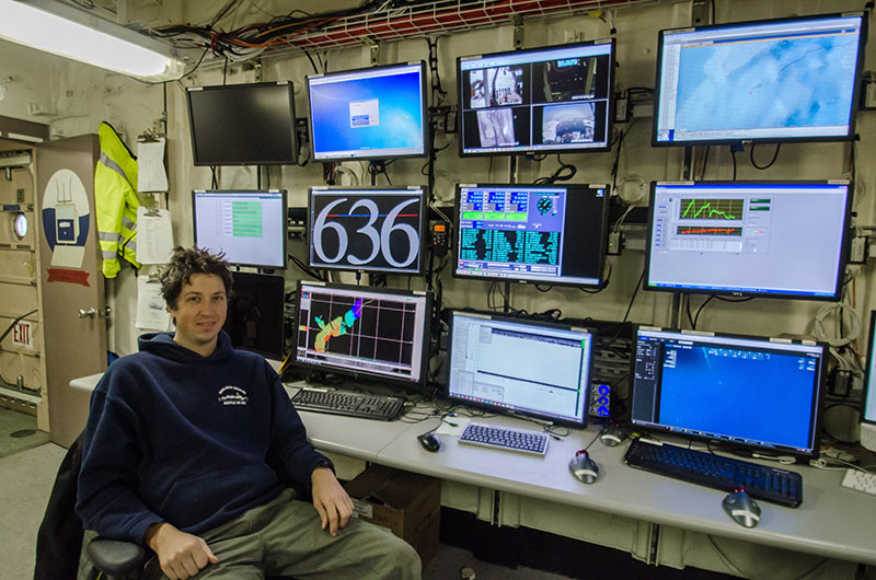 Croy Carlin sits in front of the many monitors and systems he manages, including the multibeam.