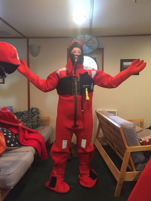 Rhian Waller demonstrates the proper way to don a survival suit.