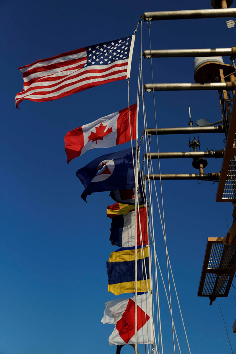 All flags ‘a’ flying as NOAA Ship Henry B. Bigelow steams to port in Newport, Rhode Island.
