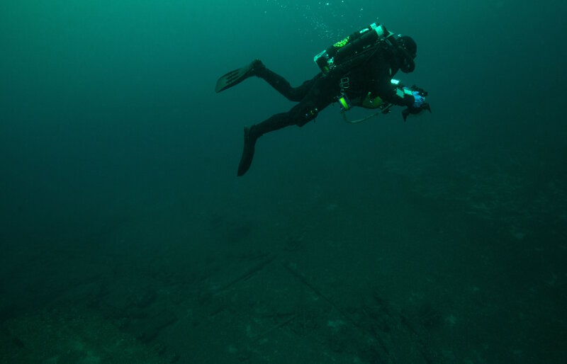 Diver Joe Hoyt swims above the debris field off the stern of wooden bulk carrier New Orleans.