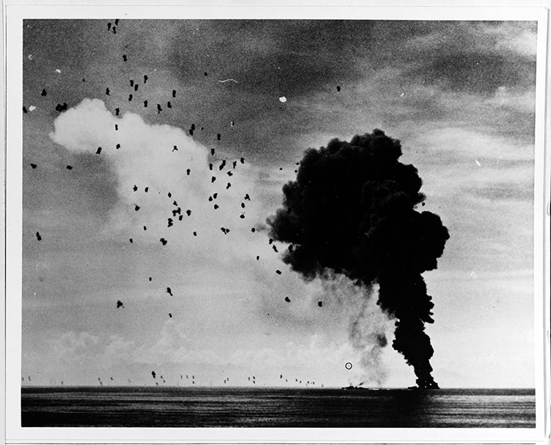 USS Abner Read (DD 526) afire and sinking in Leyte Gulf, November 1, 1944, after being hit by a kamikaze. A second Japanese suicide plane (circled) is attempting to crash another ship; however, this one was shot down short of its target.