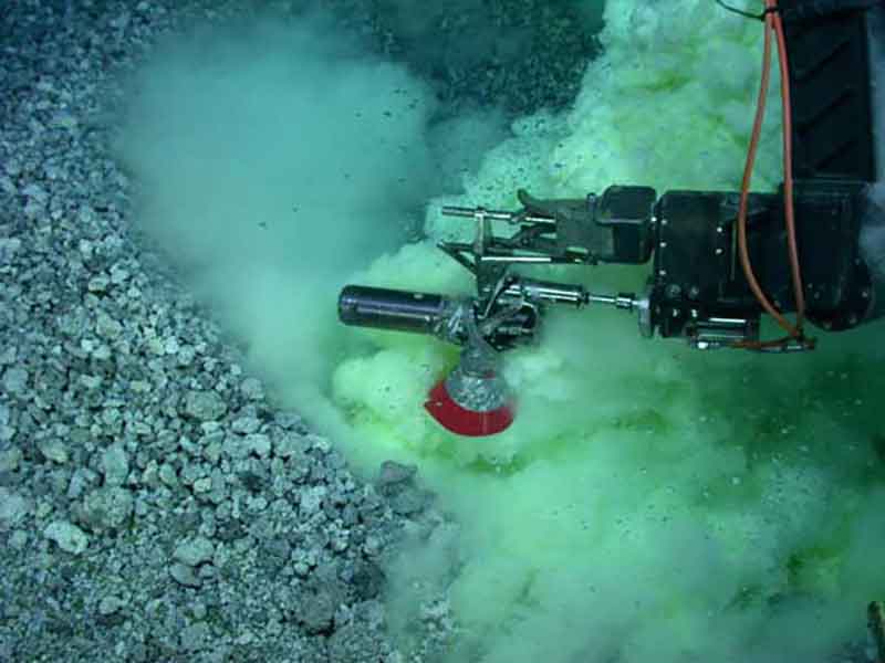 Sampling gas bubbles at an active volcanic vent on NW Rota-1 submarine volcano, Mariana Arc, March 2010. Yellow and white clouds are particles of elemental sulfur produced by degassing of sulfur dioxide from the erupting lava.