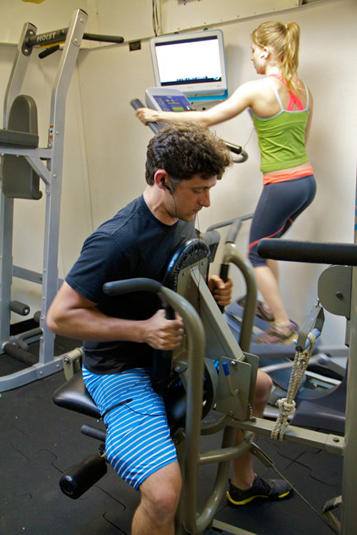 Crew members take advantage of the fully stocked gym that includes a variety of workout equipment such as weights and a treadmill.