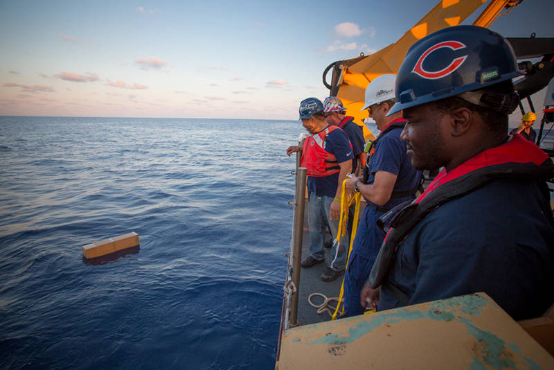 NOAA Ship Okeanos Explorer crew members watch as the Argo float drift off into the Gulf of Mexico and it begins its multi-year journey collecting valuable, constant oceanographic data.