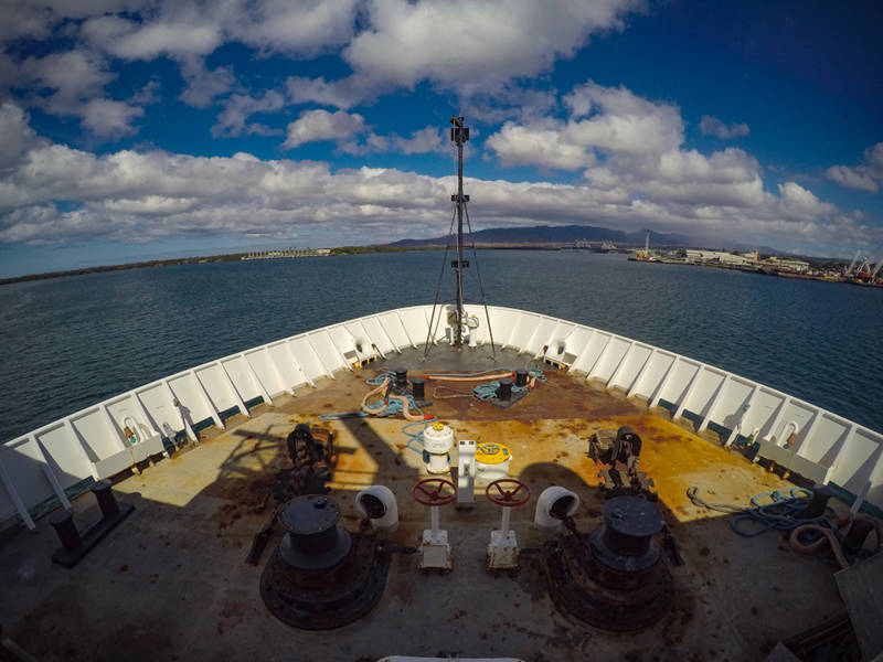 View from the bow of NOAA Ship <i>Okeanos Explorer</i> as the ship departs Pearl Harbor, Oahu, to commence Leg 2 of the 2015 Hohonu Moana: Exploring Deep Waters off Hawaiʻi expedition. Image courtesy of NOAA Ocean Exploration.