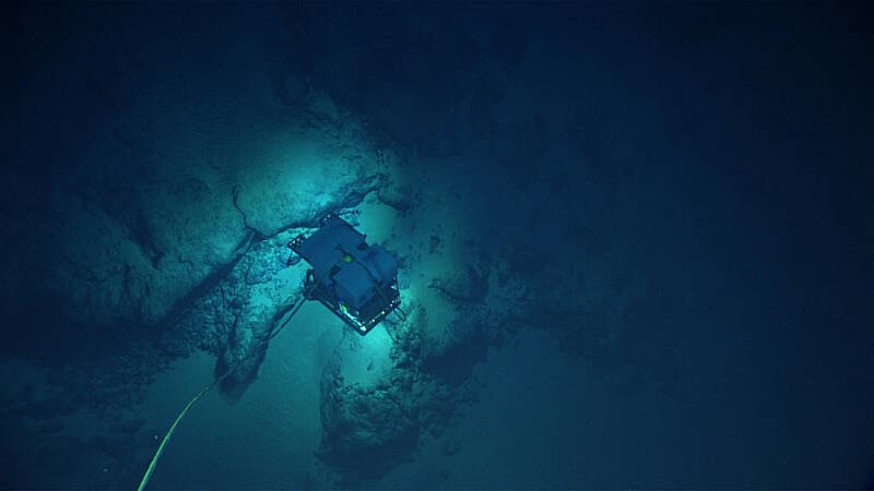 View from Seirios as remotely operated vehicle Deep Discoverer gets a closer look at a ferromanganese-encrusted outcrop.