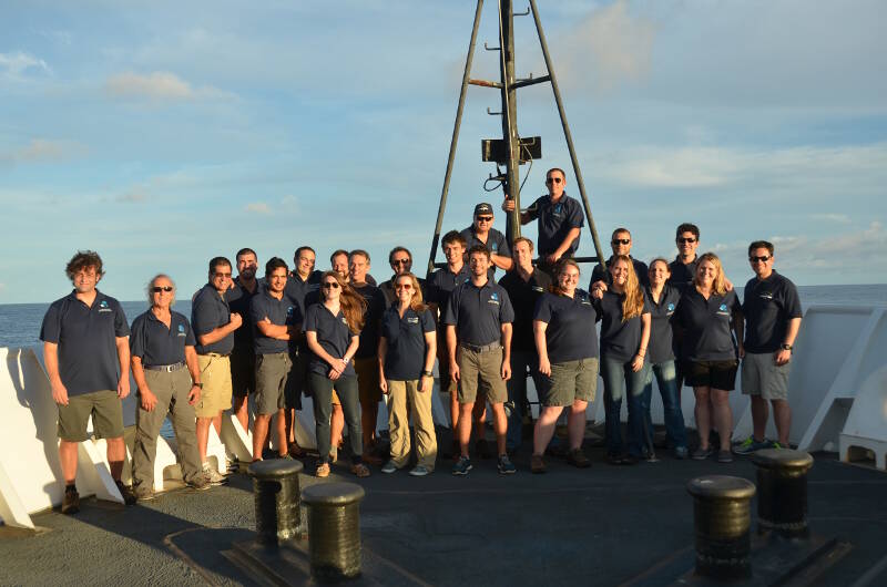The shipboard mission team poses on the bow of the Okeanos Explorer as the Discovering the Deep: Exploring Remote Pacific Marine Protected Areas expedition comes to an end.