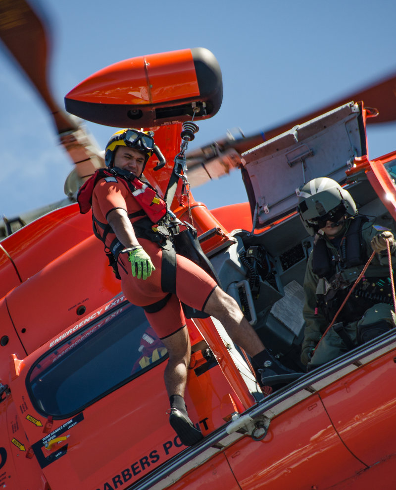 A U.S. Coast Guard rescue swimmer prepares to deploy during a training drill.
