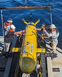 Crew members on NOAA Ship Okeanos Explorer prepare to deploy autonomous underwater vehicle Eagle Ray.