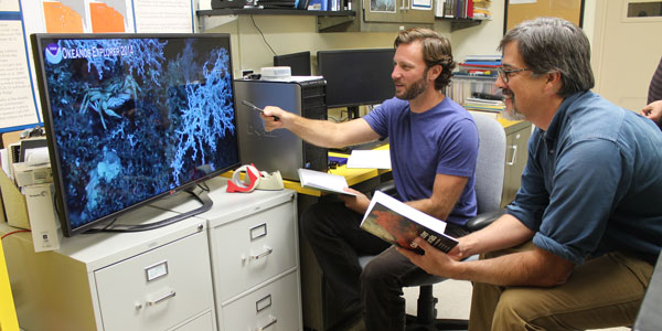 Two scientists use telepresence technology to watch live broadcast of Gulf of Mexico expedition