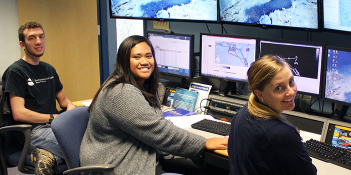 2017 explorer-in-training Claudia Thompson (center) is shown here with NOAA Ocean Exploration mapping lead Elizabeth “Meme” Lobecker (right) and fellow explorer-in-training Brandon O’Brien (left) at work at the University of New Hampshire’s Center for Coastal and Ocean Mapping.