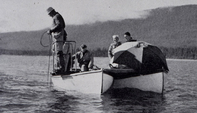 Surveyors measure seafloor depth with a handheld lead line (1942).