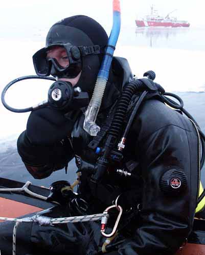Diving Supervisor Jeremy Stewart prepares to plunge into the icy Arctic water