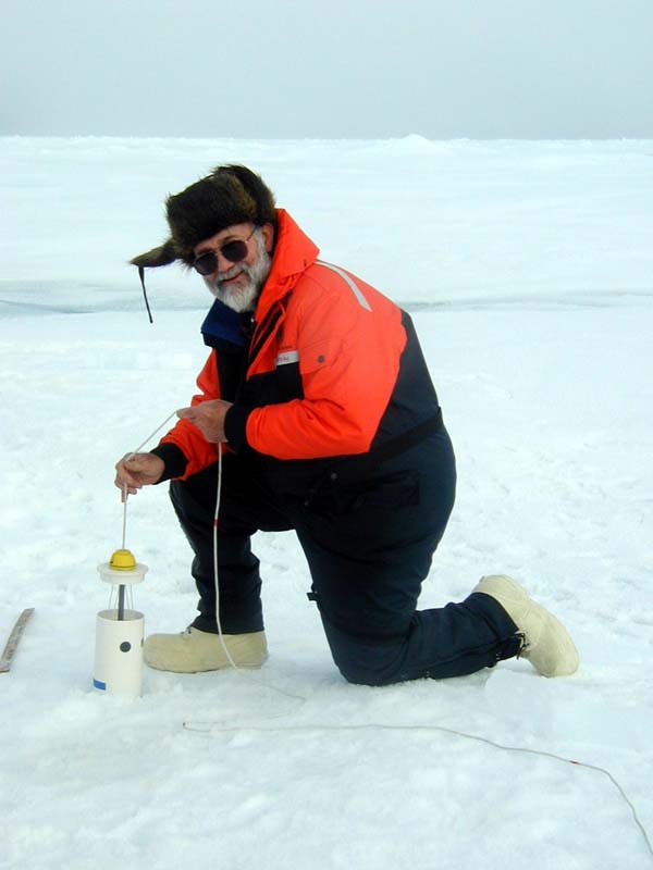 Terry Whitledge lowers a sampler through a hole in the pack ice