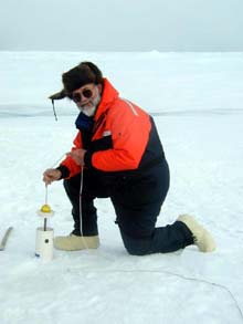 Terry Whitledge lowering a sampler through the pack ice.  