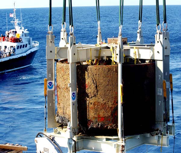 The turret of USS Monitor breaks the surface for the first time in 140 years during the Monitor Expedition 2002. Image courtesy of Monitor Expedition 2002, NOAA Ocean Exploration.