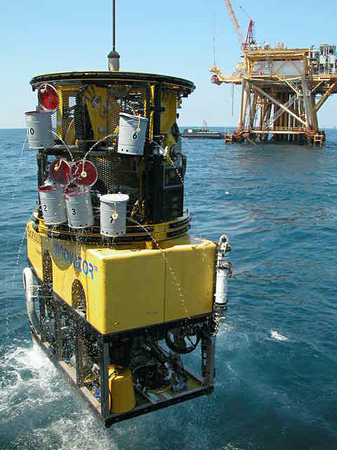 ROV Innovator during a morning launch with the Apache oil platform as a backdrop
