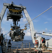 Crew members and researchers test launch-and-recovery procedures for the Johnson-Sea-Link manned submersible.