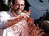 Scott France holds up a deep sea coral