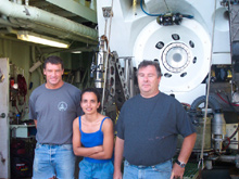 Alvin pilot in training, Mark Spear, Georgia Tech graduate student Alex Rao, and Alvin expedition leader, Pat Hickey standing in front of DSV Alvin. 