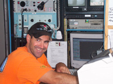 Alvin pilot Bruce Strickrott in the top lab during the satellite phone call transmission to Alvin