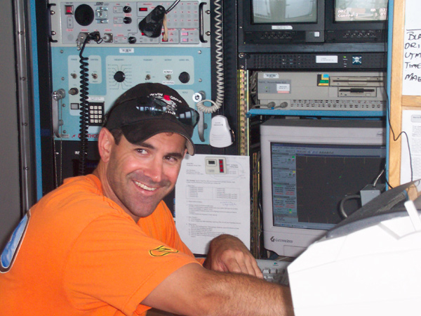 Alvin pilot Bruce Strickrott in the top lab during the satellite phone call transmission to Alvin.