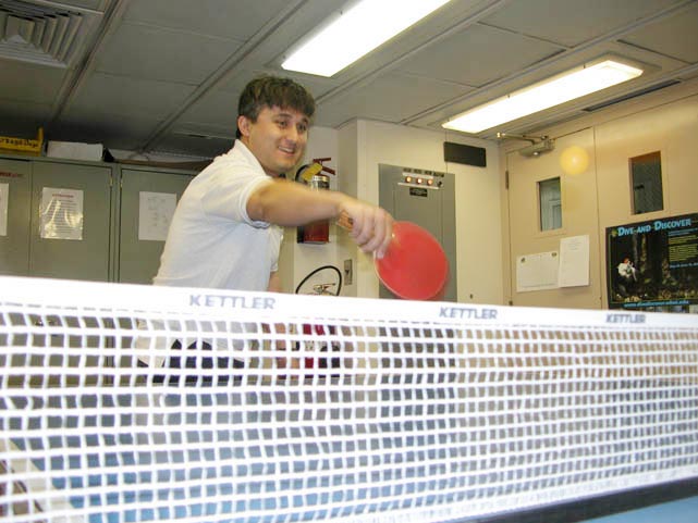 Nicolas Alverado hits a winner at the ping pong table.