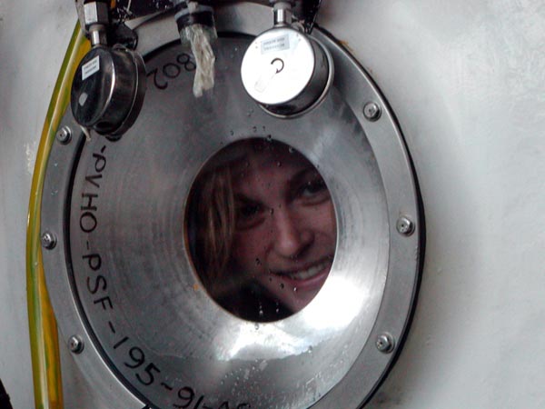 Biology teacher Sadie looks out the submersible port hole.