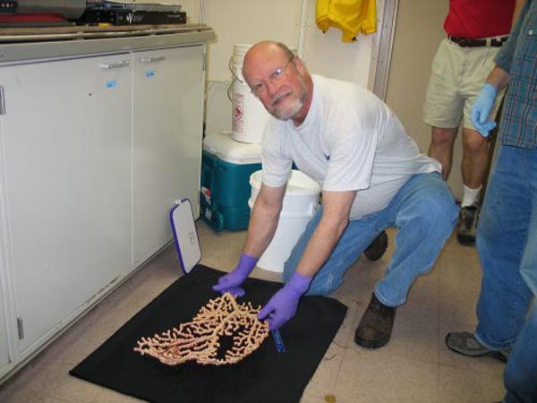 Lance Arnold assists with coral specimens.