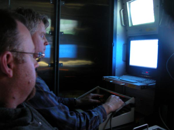 Kevin Raskoff and Joe Caba remotely fly the ROV from the control room.