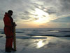 Rolf Gradinger is silhouetted by the Arctic sun while collecting one of the last ice cores of the cruise.