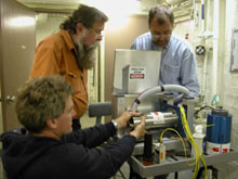 With the aid of Dale Chayes and Eben Franks, ROV operator, Jerry Caba, repairs the fiber optic rotary joint