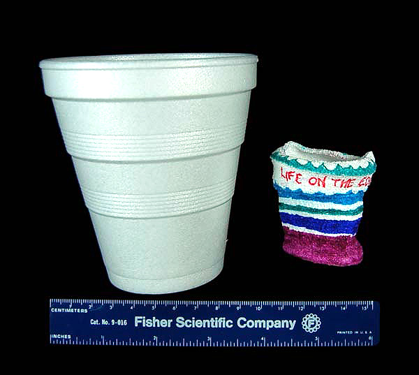 A standard 8.5-ounce styrofoam cup compared with a cup, originally the same size, that has been attached to exterior of theJohnson-Sea-Linksubmersible and taken to operating depth
