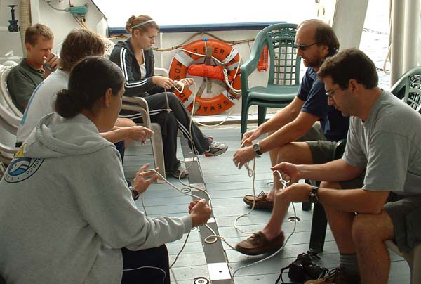 Dr. Ross (on the right, in sunglasses) teaches an impromptu knot-tying class as we return offshore to resume the expedition.