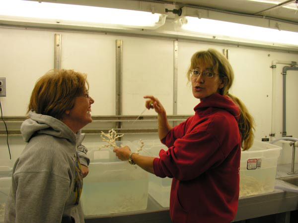 Teacher Tracy Griffin discusses the health of the Lophelia coral being kept in the onboard 'cold room' with Principal Investigator Dr. Sandra Brooke.
