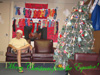 Co-Principal Investigator Edward Baker poses in front the ship's fireplace and Christmas tree.