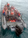 Science and crew members depart the research vessel.